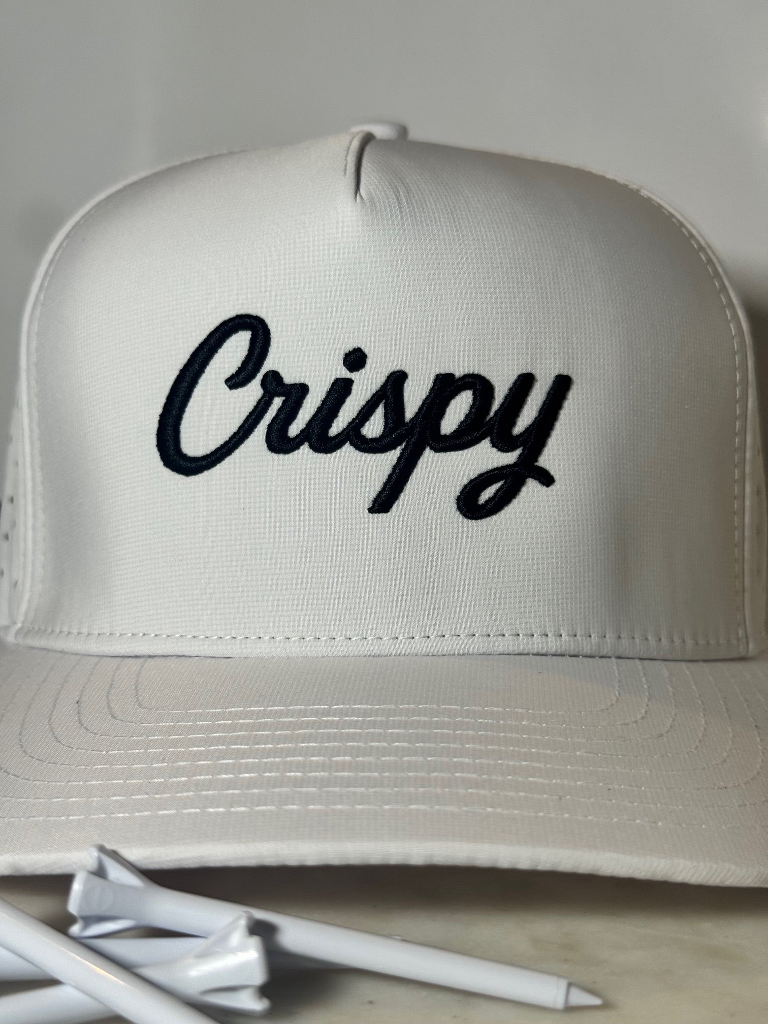White hat with 'Crispy' text on a light background